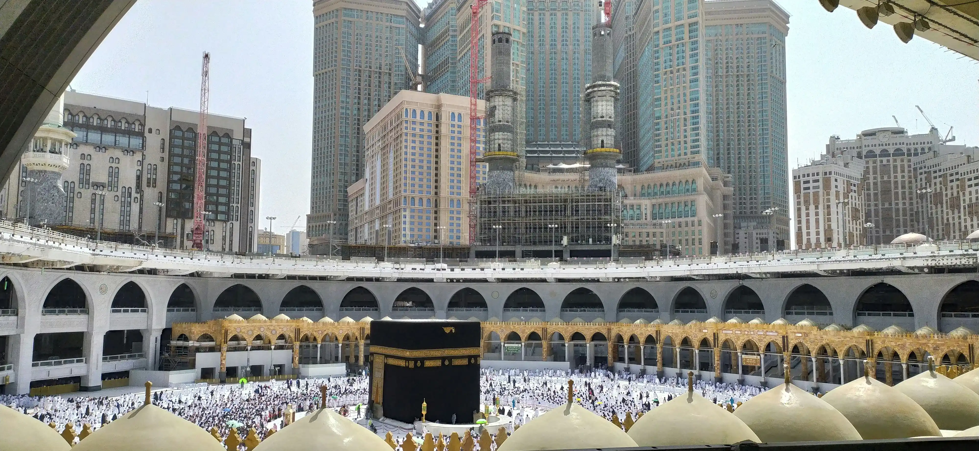 Kaaba in Mecca at night with crowds of pilgrims
